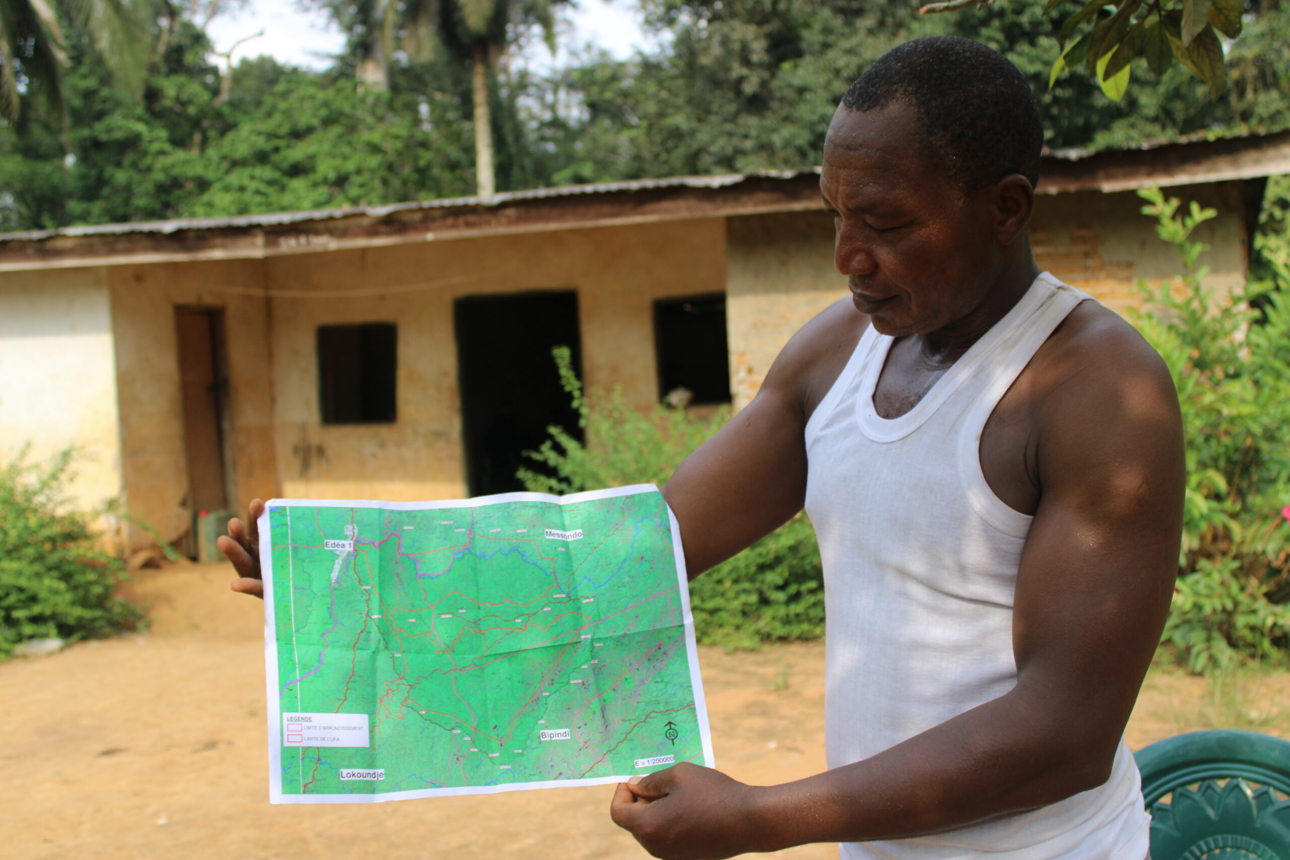A native of Nkollo/South Cameroon showing how the map of the FMU to the communities members. Image by InfoCongo